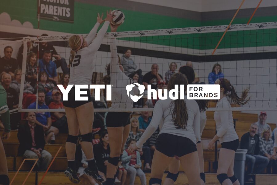 Yeti and Hudl for Brands logos overlaying a darkened volleyball play at the net.